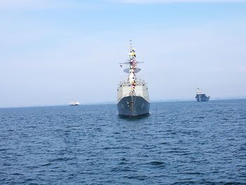 Ship sailing on sea against sky