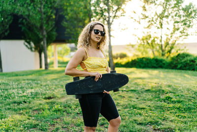 Full length portrait of woman on field