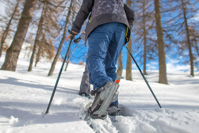 Low section of man on snow covered field