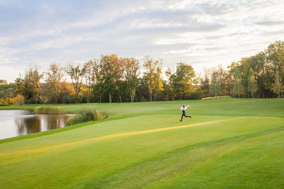 Scenic view of golf course against sky