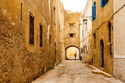 Alley amidst buildings in city