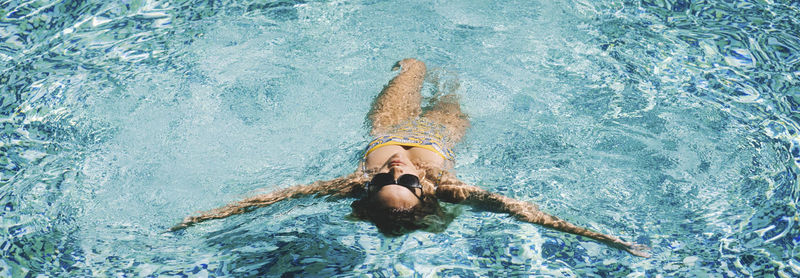 High angle view of woman swimming in sea