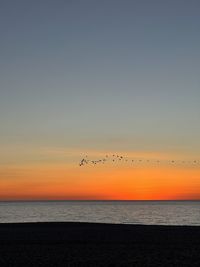 Scenic view of sea against clear sky during sunset