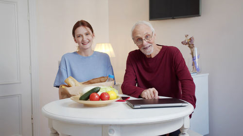 Portrait of senior man with nurse at rehab center