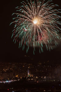 Low angle view of firework display at night