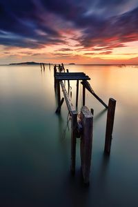 Silhouette boat on sea against sky during sunset