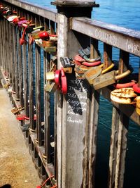 Close-up of padlocks hanging on water