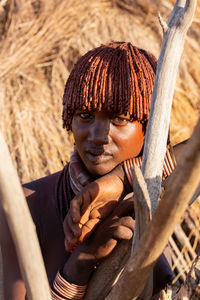 Close-up portrait of girl sitting on wood