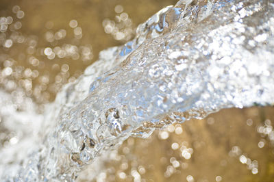 Close-up of water splashing against blurred background