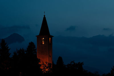 Silhouette of building against sky at dusk