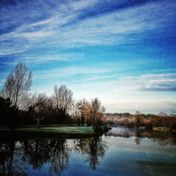 Scenic view of lake against cloudy sky