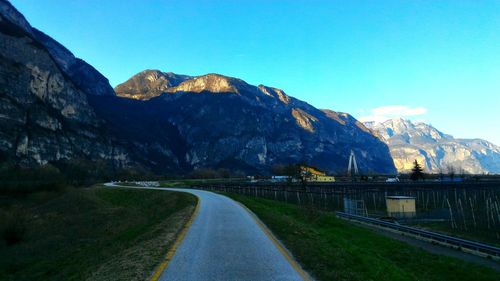 Empty road leading towards mountains