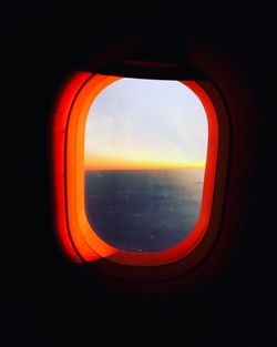 View of sky through window during sunset