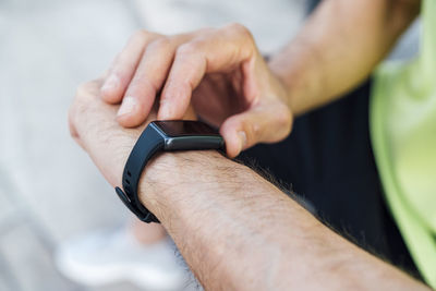 Mature man using fitness tracker