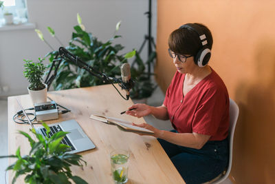 High angle view of woman podcasting