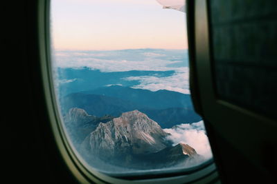 Scenic view of mountains seen through airplane window