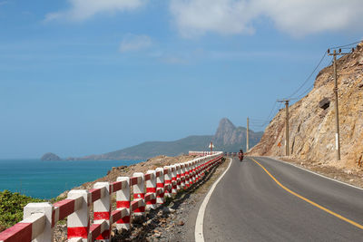 Road by sea against sky