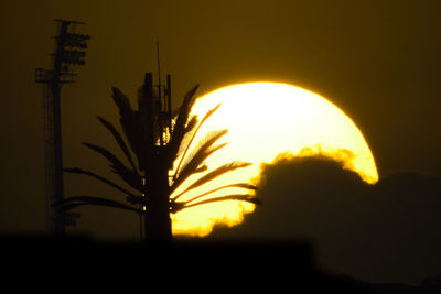 Low angle view of silhouette sun against sky during sunset