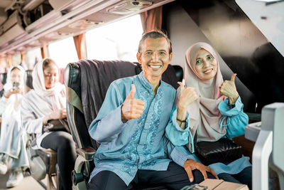 Portrait of young woman sitting in bus