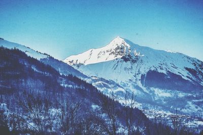 Scenic view of snow covered mountains against sky