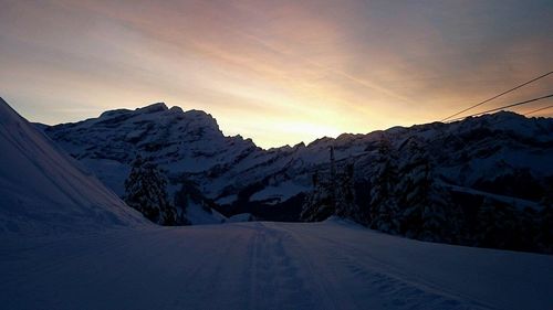 Scenic view of snow covered mountains against sky