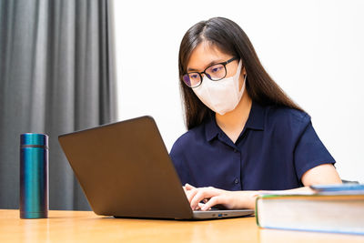 Young woman using laptop on table