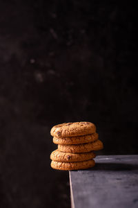 A stack of chocolate cookies on the edge of the table
