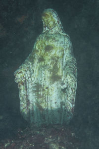 Close-up of statue against stone wall