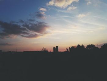 Silhouette trees against sky during sunset