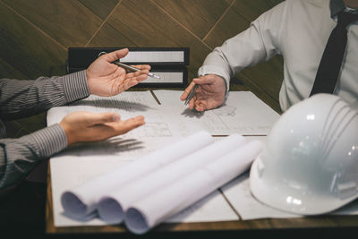 Midsection of man using laptop on table