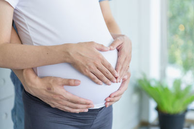 Midsection of woman holding hands