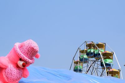 Amusement park ride against blue sky
