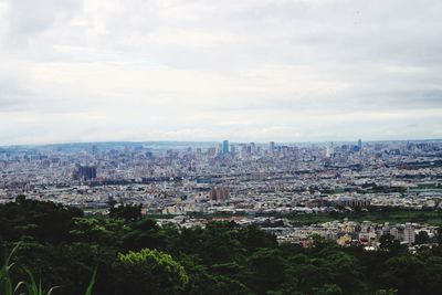 Cityscape against cloudy sky