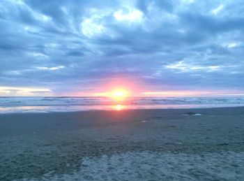 Scenic view of beach against sky during sunset