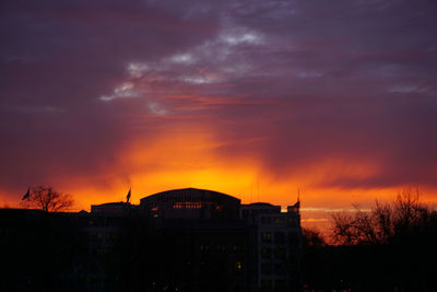 Silhouette of built structure against sunset sky