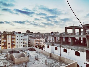 Buildings against cloudy sky