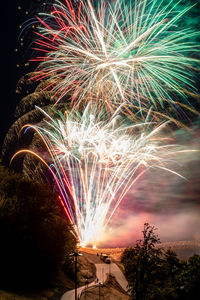 Low angle view of firework display at night