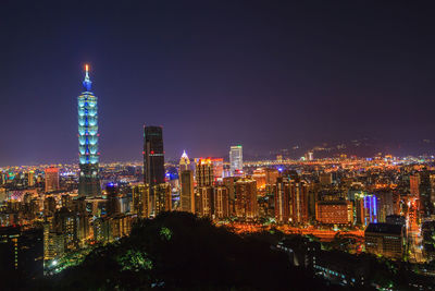 Panoramic view of illuminated buildings against sky at night