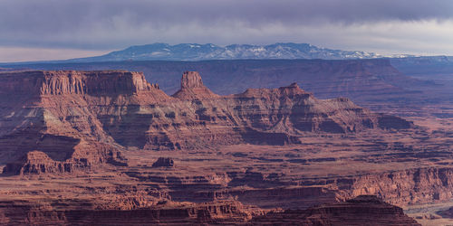 Rugged red sandstone rock formations tower above the eroded landscape