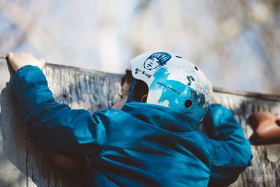 Close-up of man against blue sky