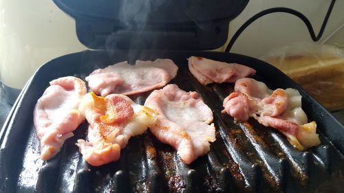 High angle view of meat on barbecue grill