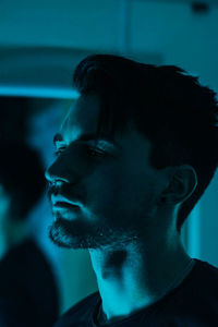 Close-up portrait of young man looking away