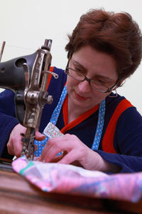 Close-up of woman stitching fabric