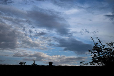 Low angle view of silhouette trees on field against sky