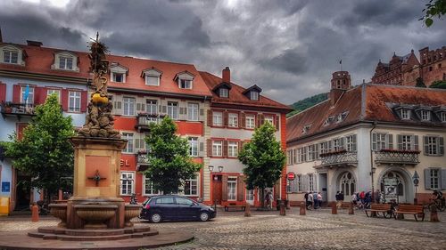 Houses against cloudy sky