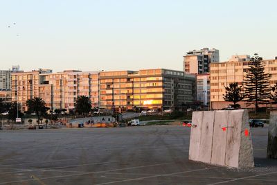 Buildings in city against clear sky