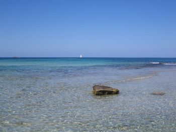 Lone sailboat in calm blue sea