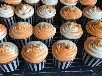 View of cupcakes with orange icing on it