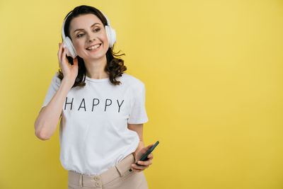 Portrait of a smiling young woman using smart phone