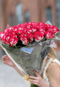 Close-up of hand with pink flowers